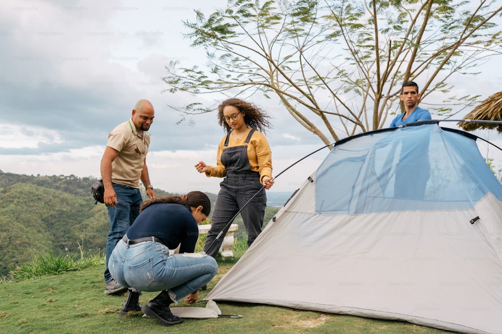 a group of people standing around a tent