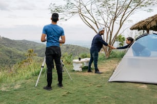 a couple of men standing next to a tent
