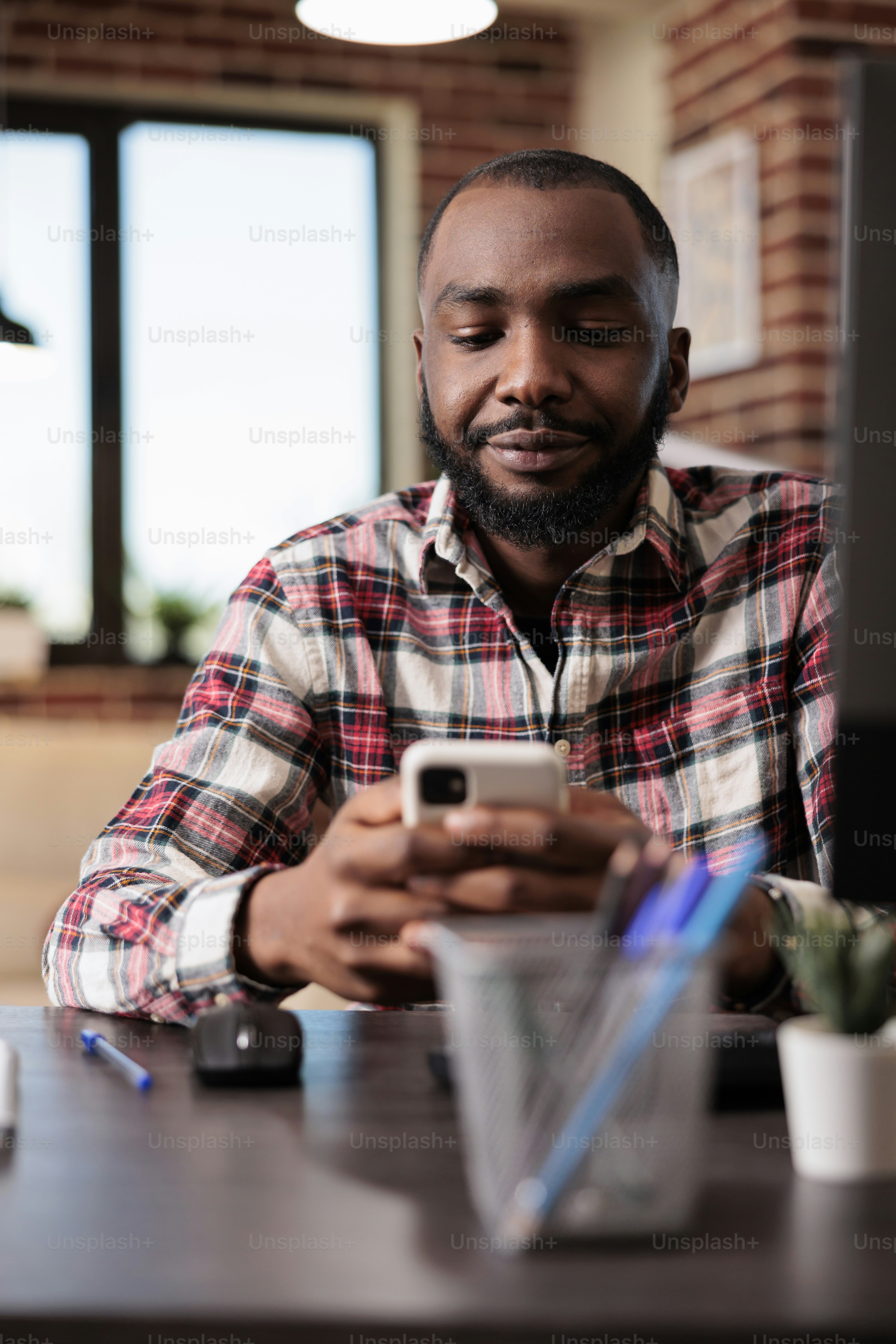 Male freelancer browsing internet on smartphone, using website app and ...