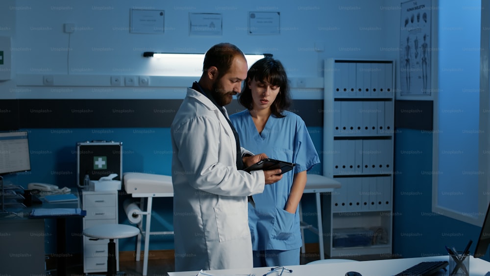 Physician doctor analyzing patient disease expertise with nurse discussing diagnosis expertise planning healthcare treatment during checkup visit appointment. Medicine service and concept