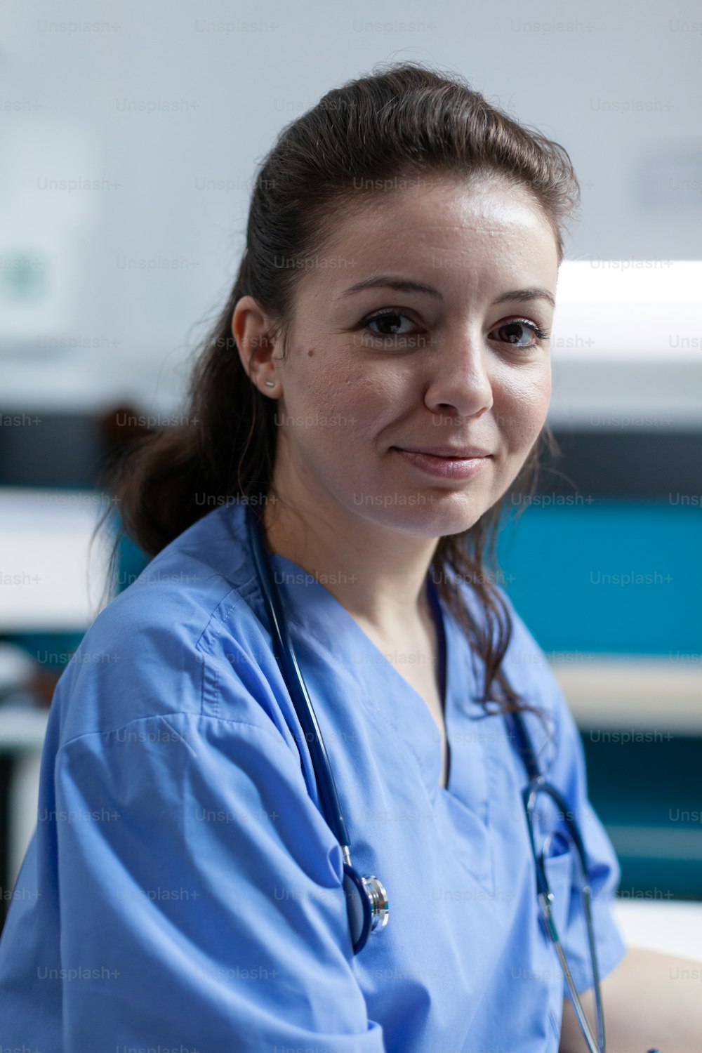 Portrait of practitioner nurse with medical stethoscope analyzing pharmaceutical prescription during clinical appointment in hospital office. Woman asisstance checking sickness symptoms