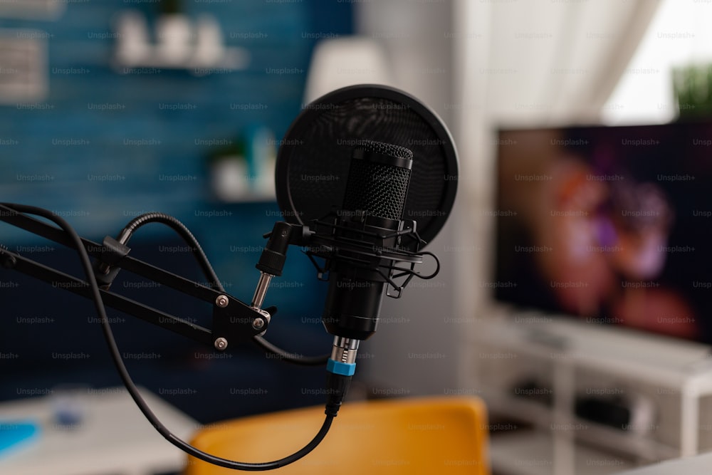 Closeup of recording microphone in home studio. Professional live broadcast equipment to record content on social media. Electronic audio livestream technology on desk. Podcast instrument.