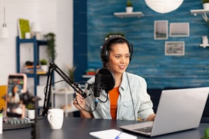 Social media influencer discussing about vlogging in home studio recording podcast. New media star making online fashion content with professional equipment for subscribers audience