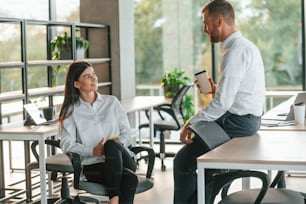 Man and woman are working in the modern office together.