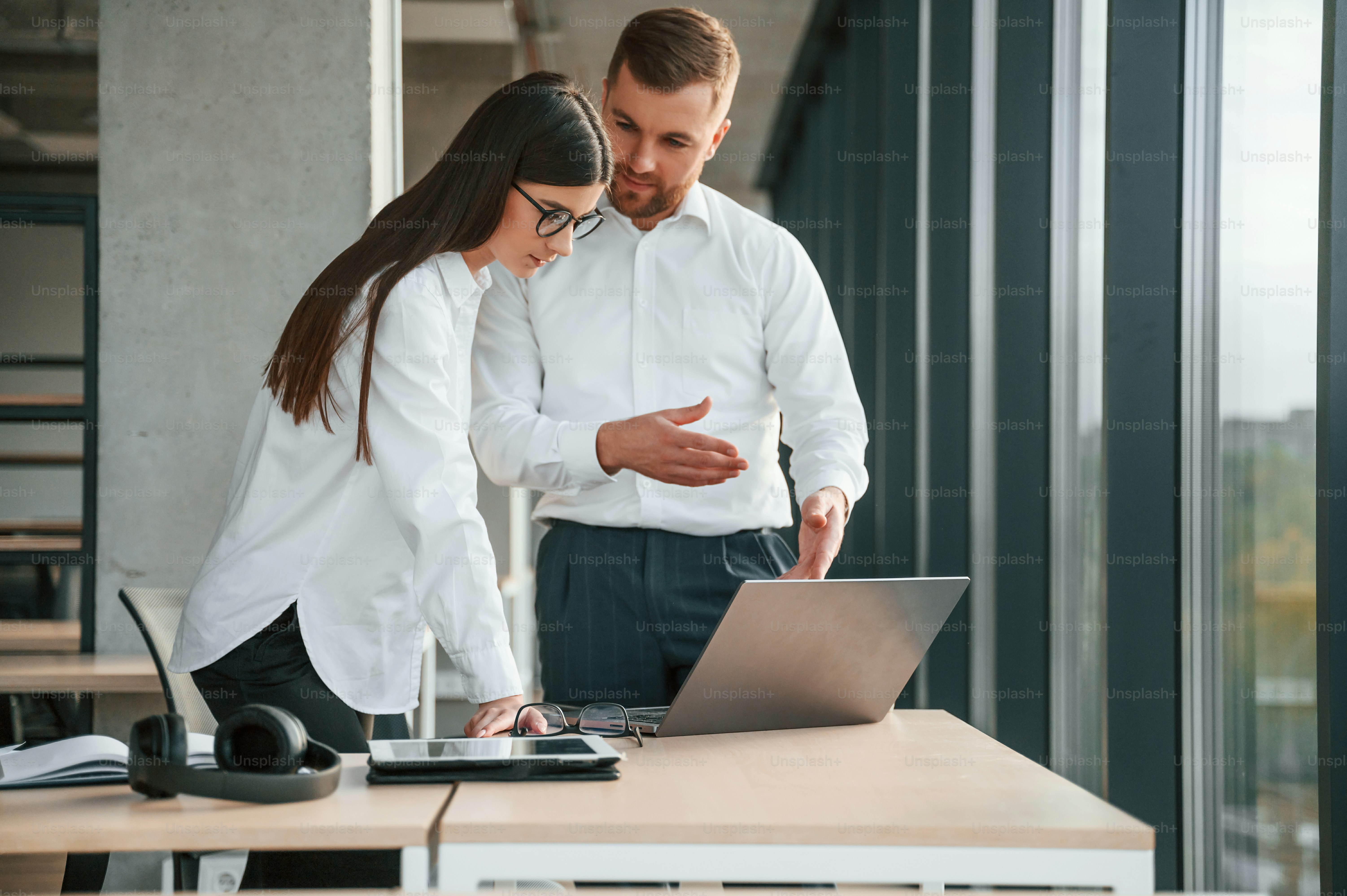 Man and woman are working in the modern office together.