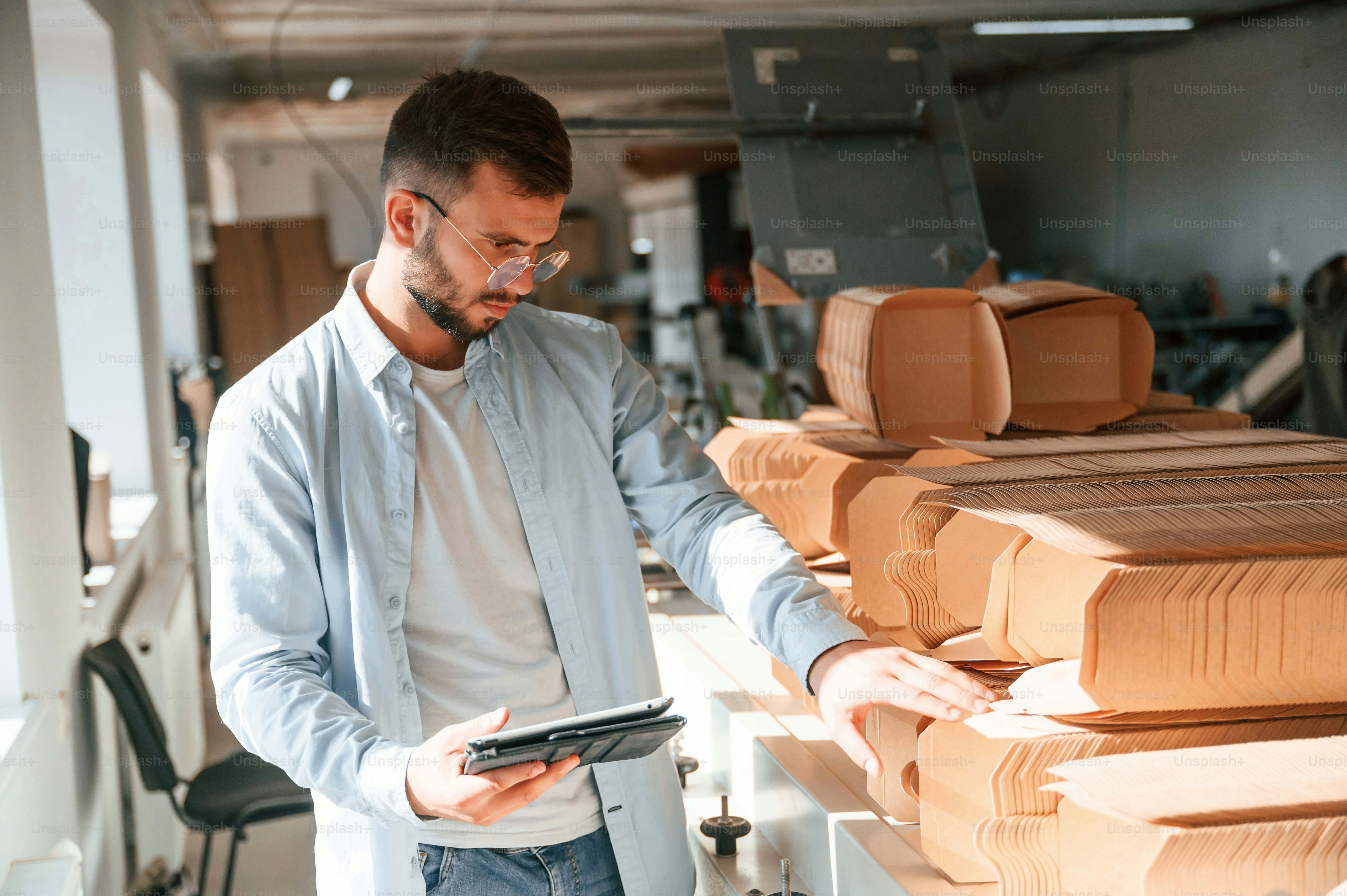 With notepad in hand. Print house worker in white clothes is indoors.