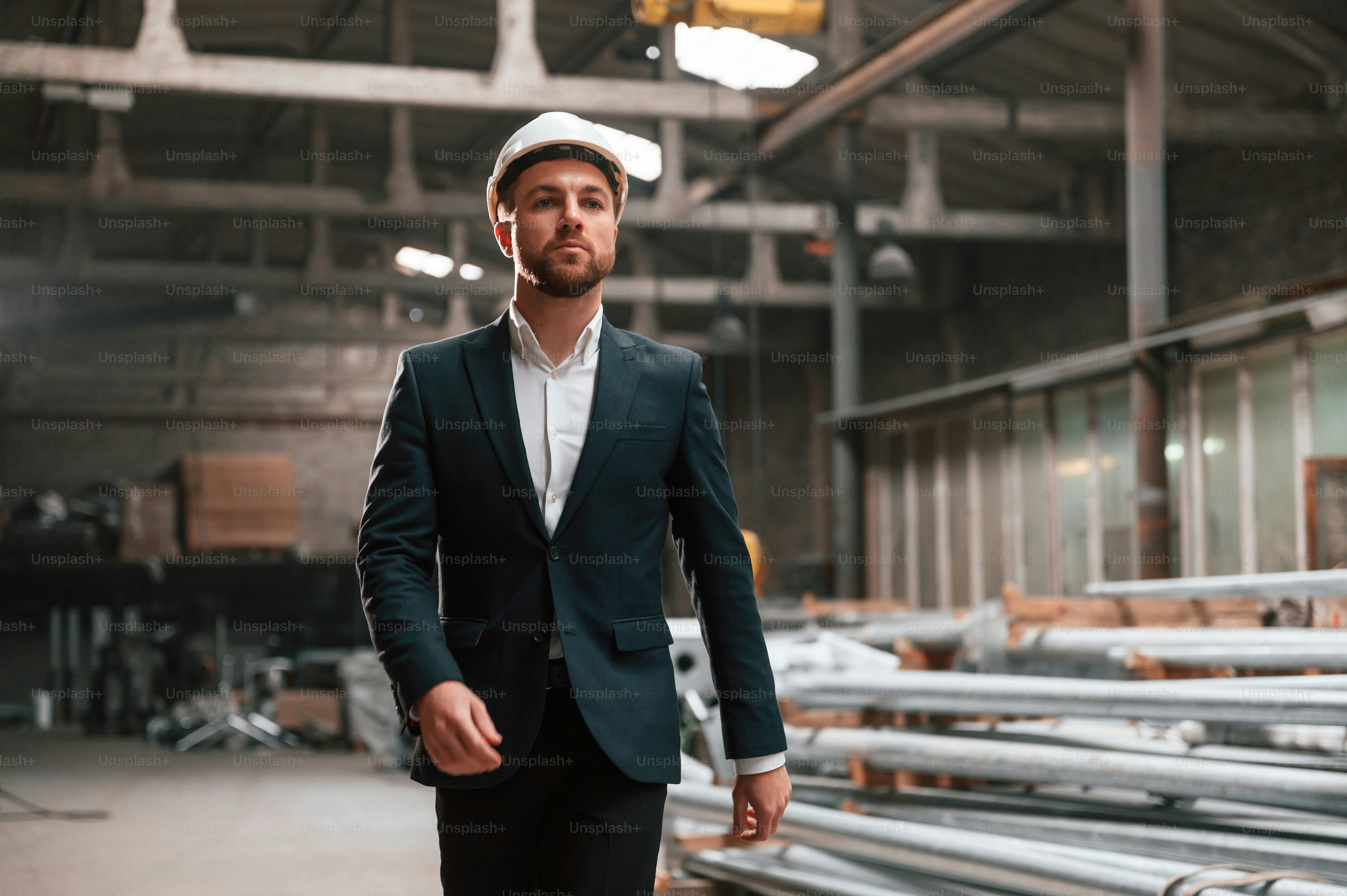 Portrait of manager that is in black formal wear at the factory. photo ...