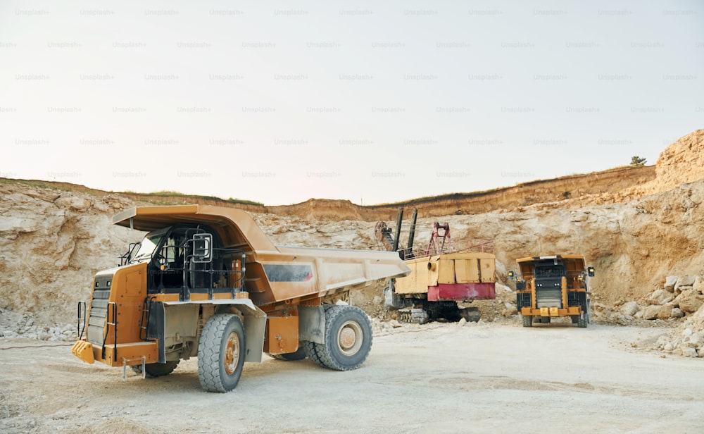 Loading vehicle is outdoors on the borrow pit at daytime.