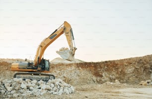 Loading vehicle is outdoors on the borrow pit at daytime.