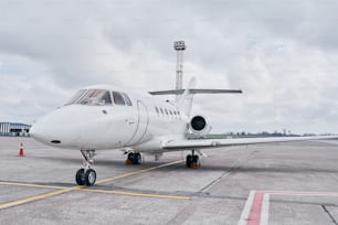 Front view. Turboprop aircraft parked on the runway at daytime.