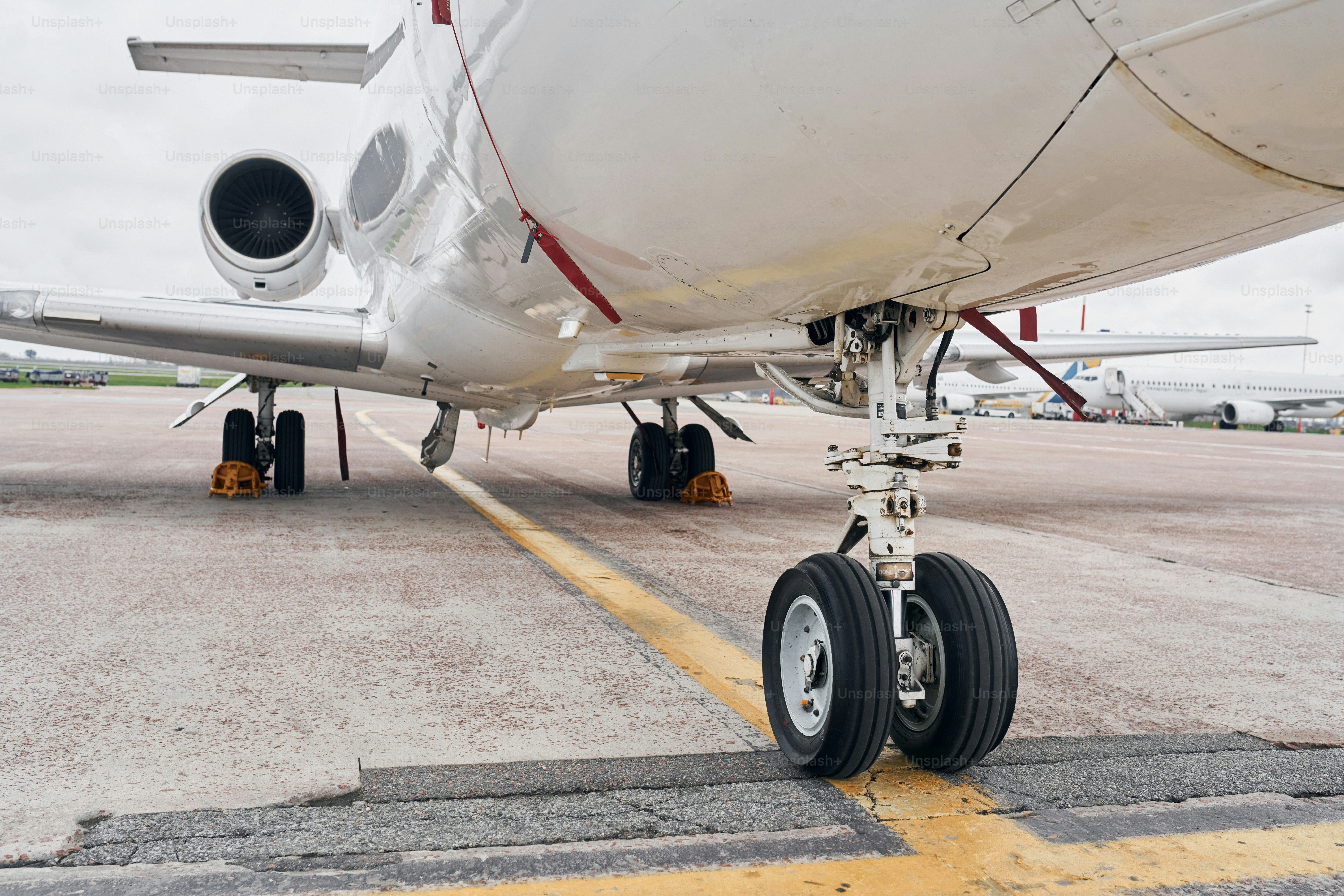 View from below. Turboprop aircraft parked on the runway at daytime.