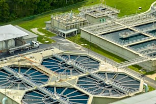 Aerial view of modern water cleaning facility at urban wastewater treatment plant. Purification process of removing undesirable chemicals, suspended solids and gases from contaminated liquid.
