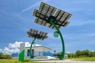 Solar photovoltaic panels mounted on city street pole for electricity supply of streetlights and surveillance cameras.