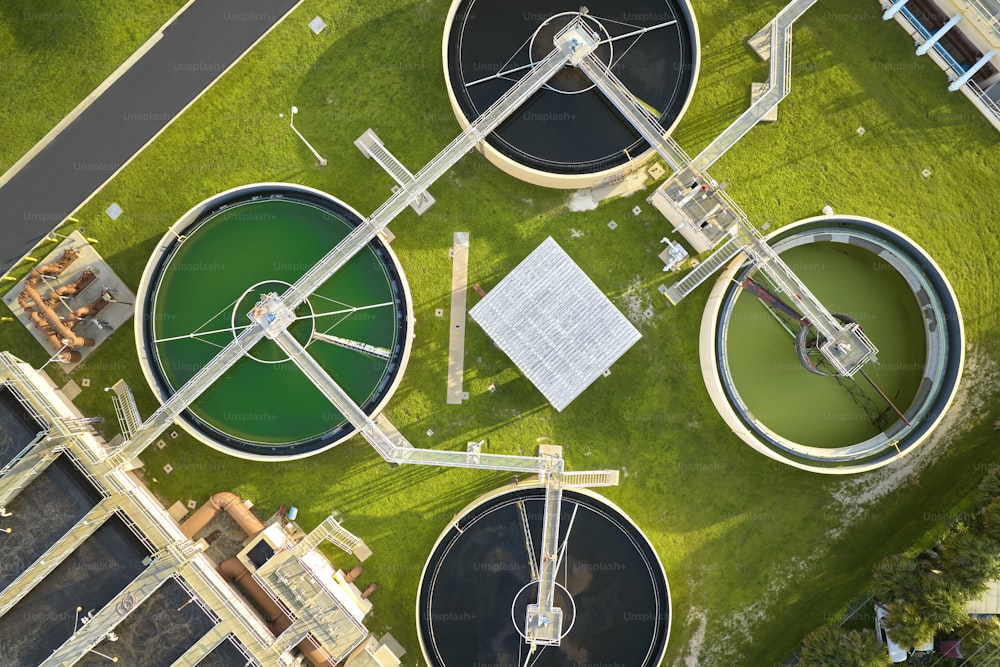 Aerial view of modern water cleaning facility at urban wastewater treatment plant. Purification process of removing undesirable chemicals, suspended solids and gases from contaminated liquid.