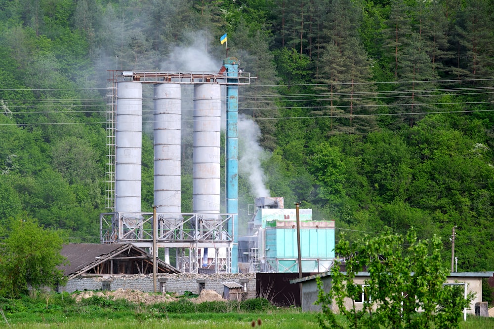 Cement plant with high metal factory structure at industrial production area. Manufacture and global industry concept.