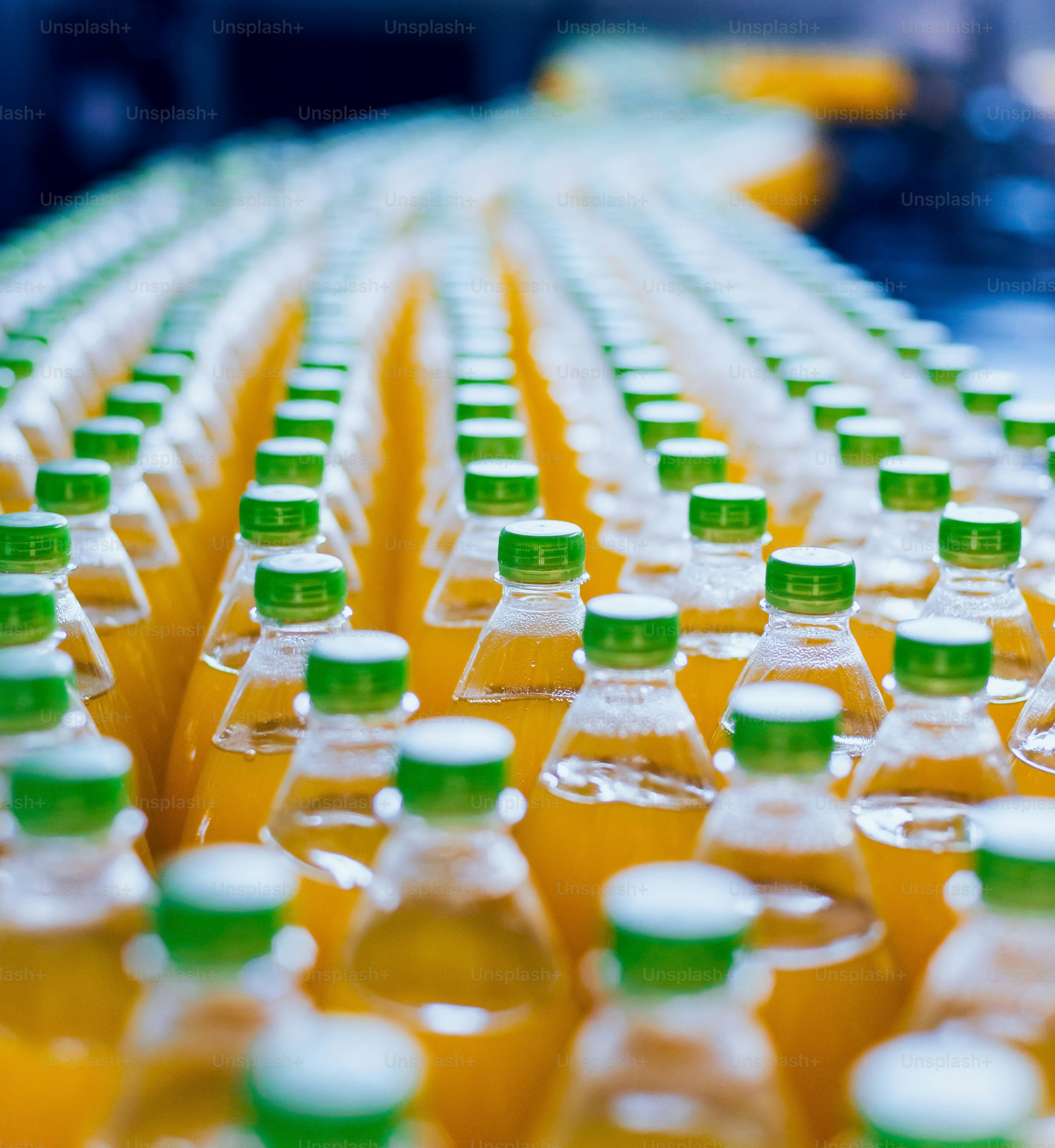 Conveyor with bottles for juice or water. Beverages factory equipments. Background