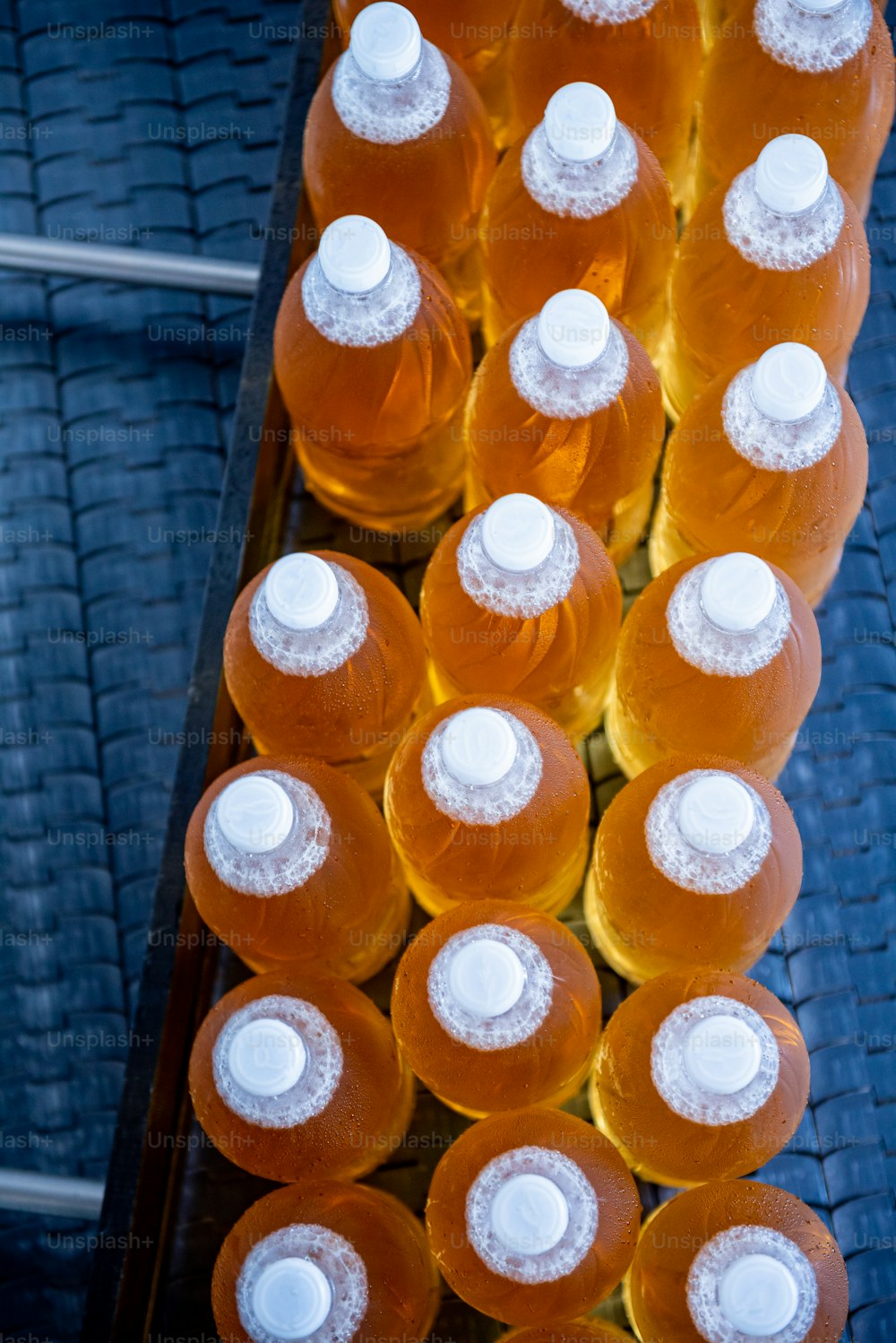 Bande transporteuse avec bouteilles pour jus ou eau dans une usine de boissons moderne.