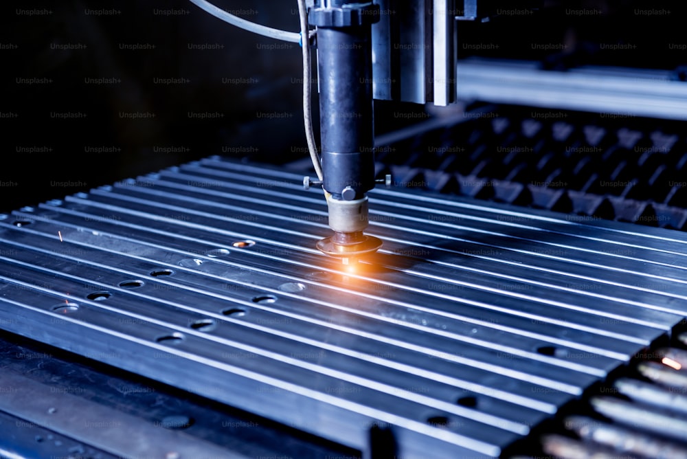 The laser cutting machine cutting the holes on pipes.