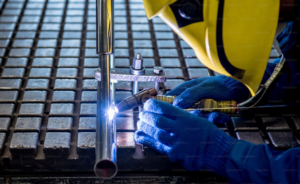 Welder working in a steel factory with argon welding.