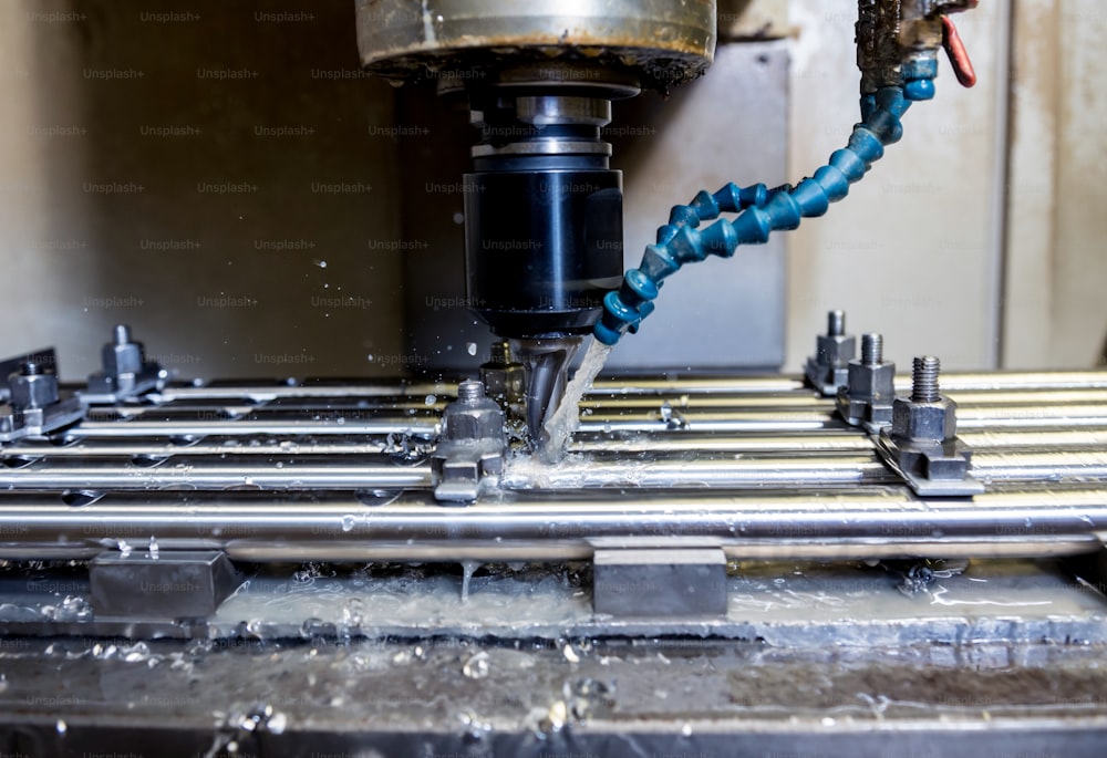 CNC milling machine drills holes in the pipe