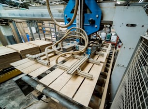 Production line of the wooden floor factory. CNC automatic woodworking machine. Industrial background