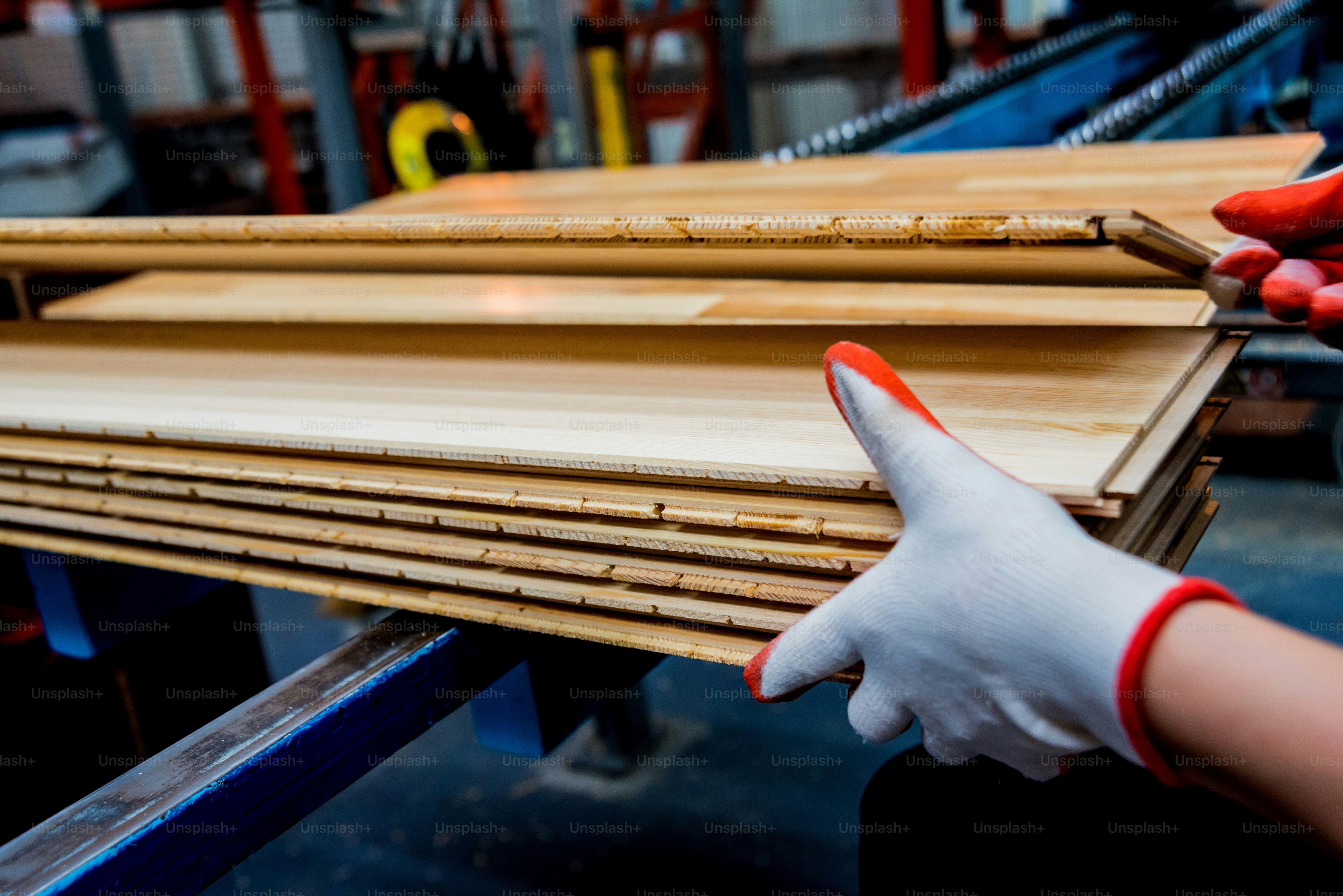 Carpenter with fibreboards at furniture factory workshop. Woodworking industry concept
