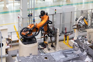 Photo of automobile production line. Welding car body. Modern car assembly plant. Auto industry. Interior of a high-tech factory, modern production.