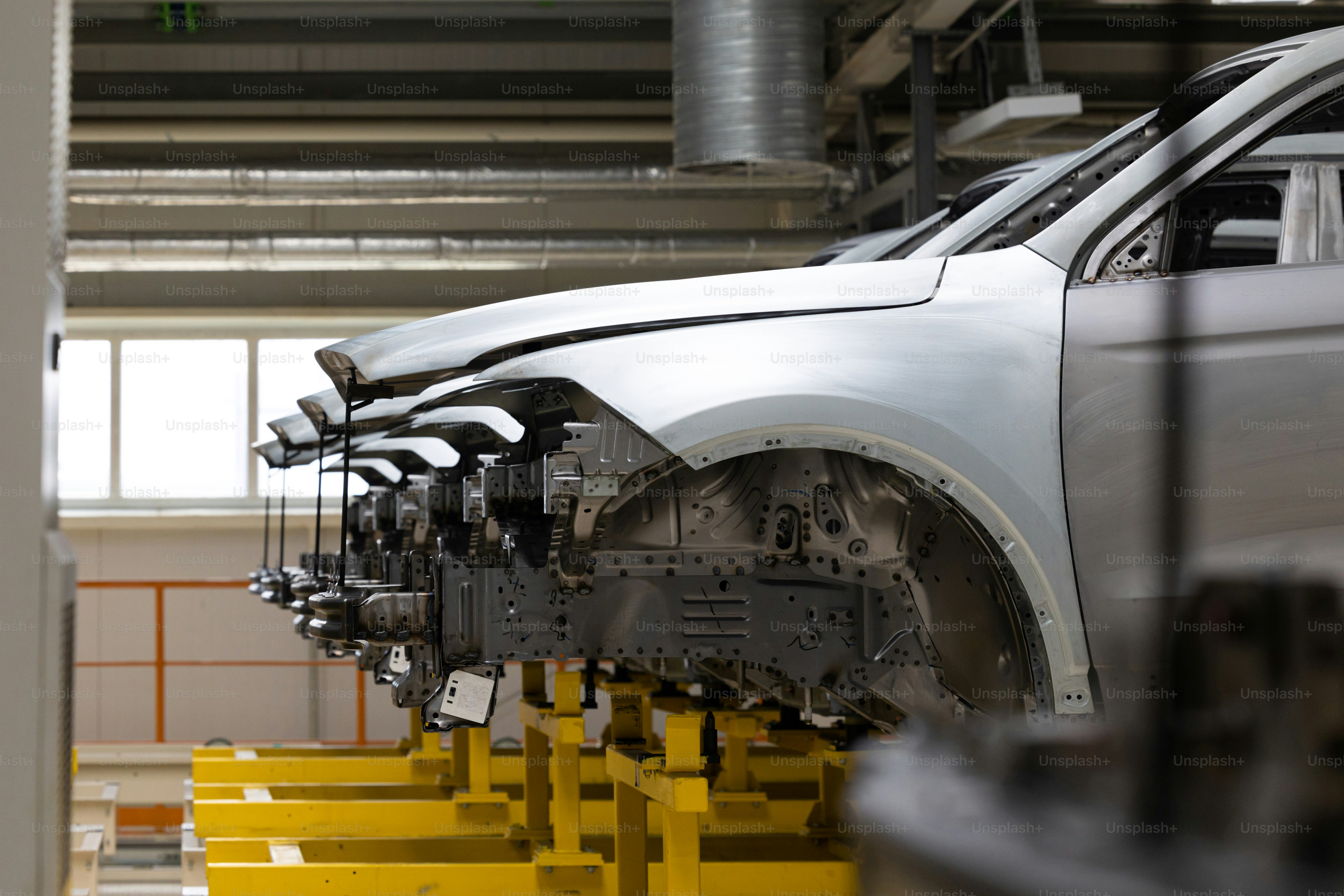 Photo of automobile production line. Welding car body. Modern car assembly plant. Auto industry. High-tech factory.
