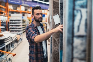 the buyer in the store chooses a carpet.