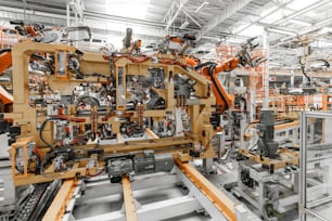 Photo of automobile production line. Welding car body. Modern car assembly plant. Auto industry. Interior of a high-tech factory, modern production.