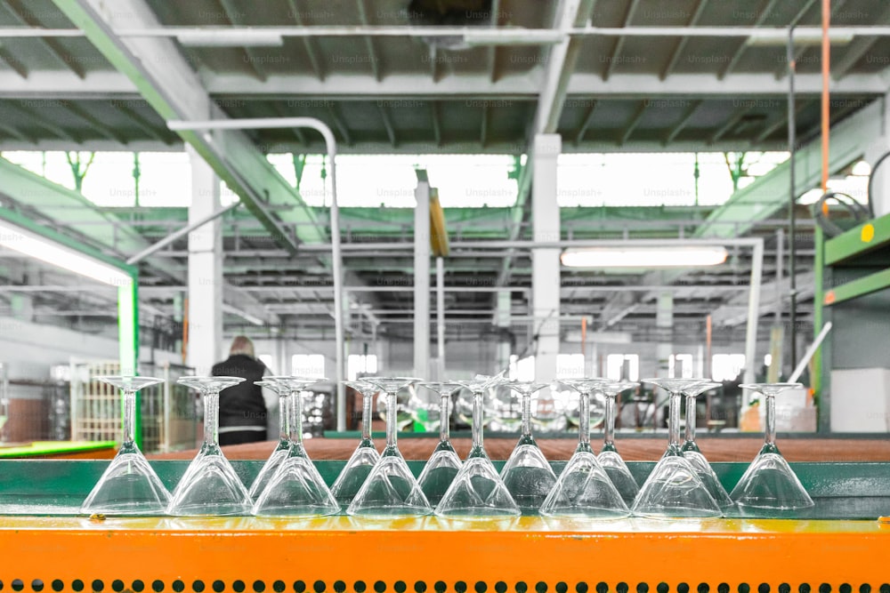 Glass producing at factory stemware in a row