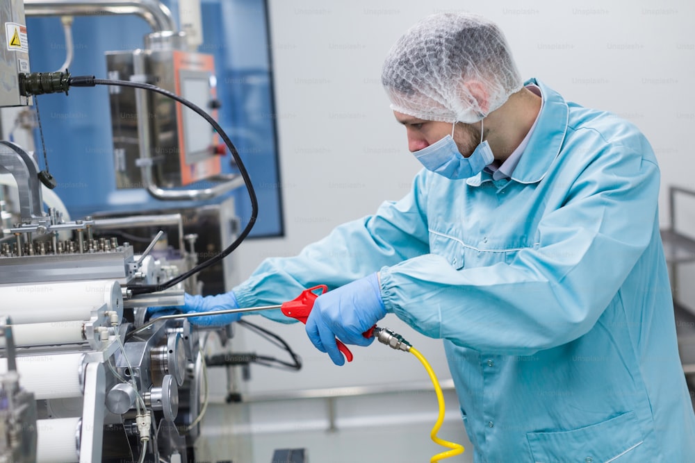 scientist in blue lab suit fix machine