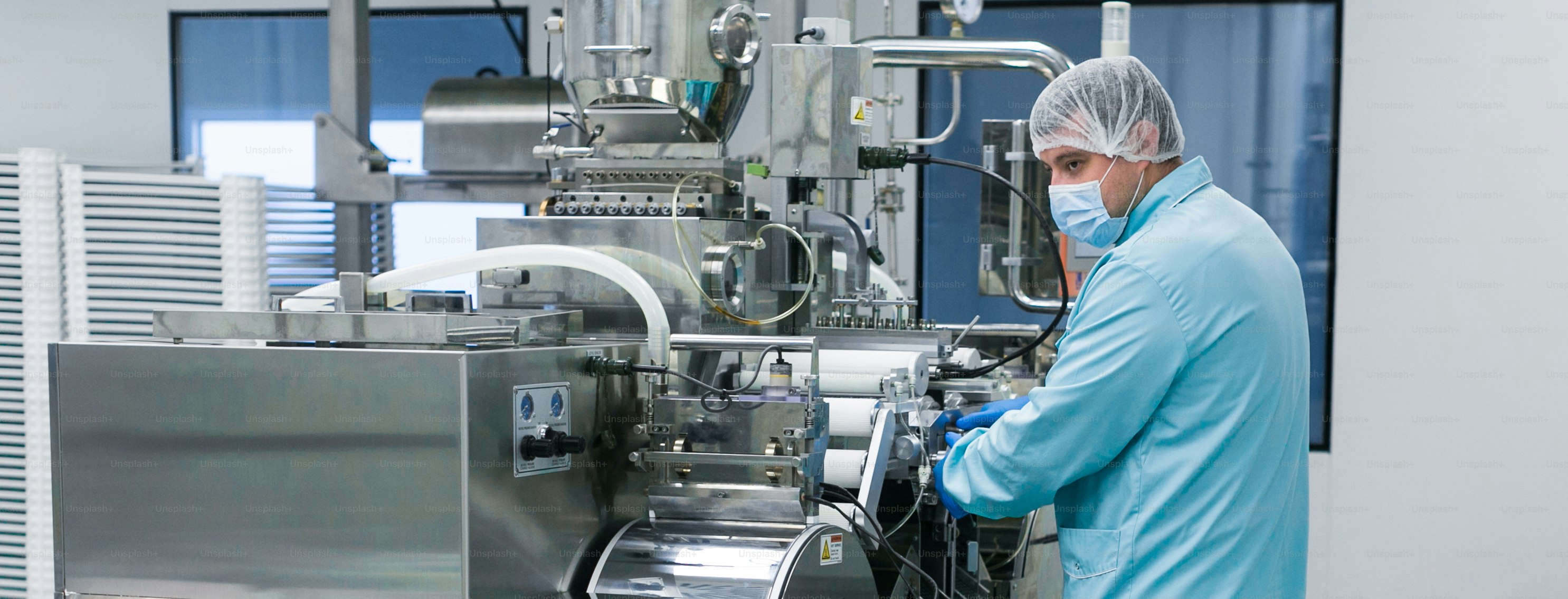 Factory worker in white suit is checking readings photo – Technology ...