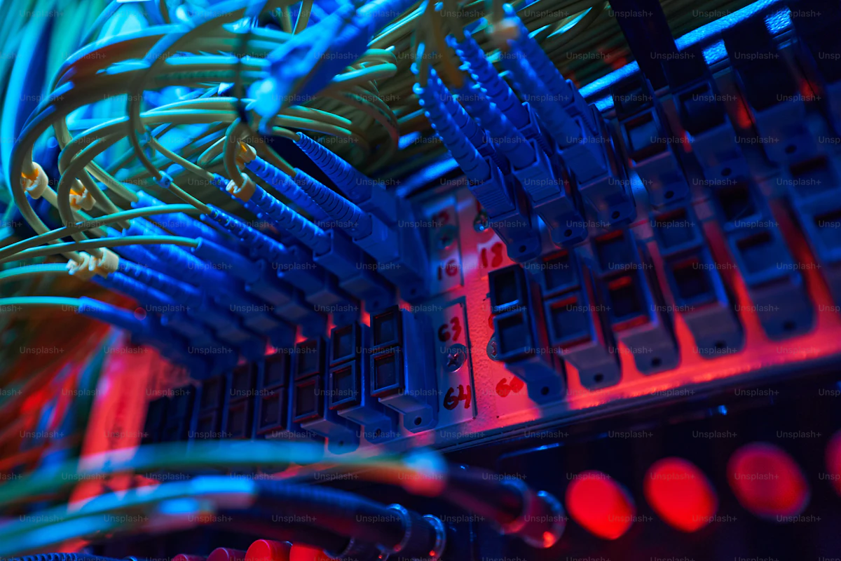 Blue optical fiber cables plugged into a switch panel inside a server rack, representing remote MCP transports