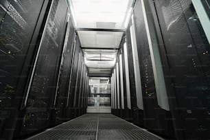 Empty passageway between server cabinets in a room of data retention facility