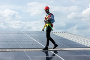 Engineer working setup Solar panel at the roof top. Engineer or worker work on solar panels or solar cells on the roof of business building