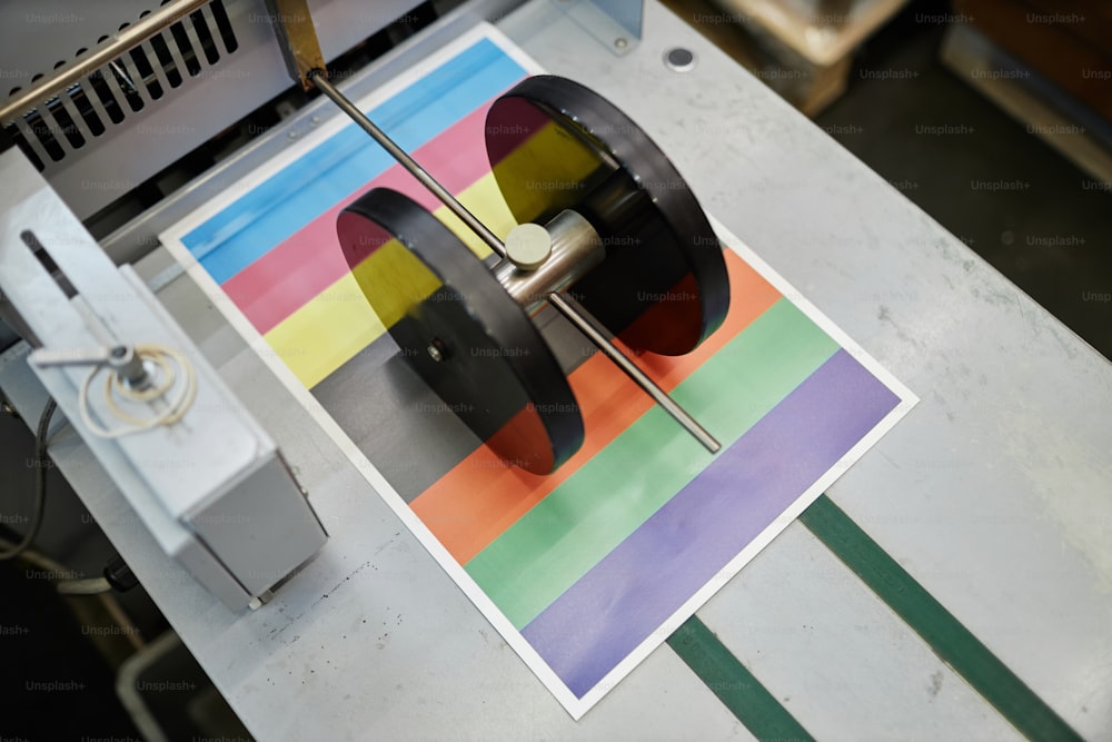 Top view of industrial printing machine with color test sheet, copy space