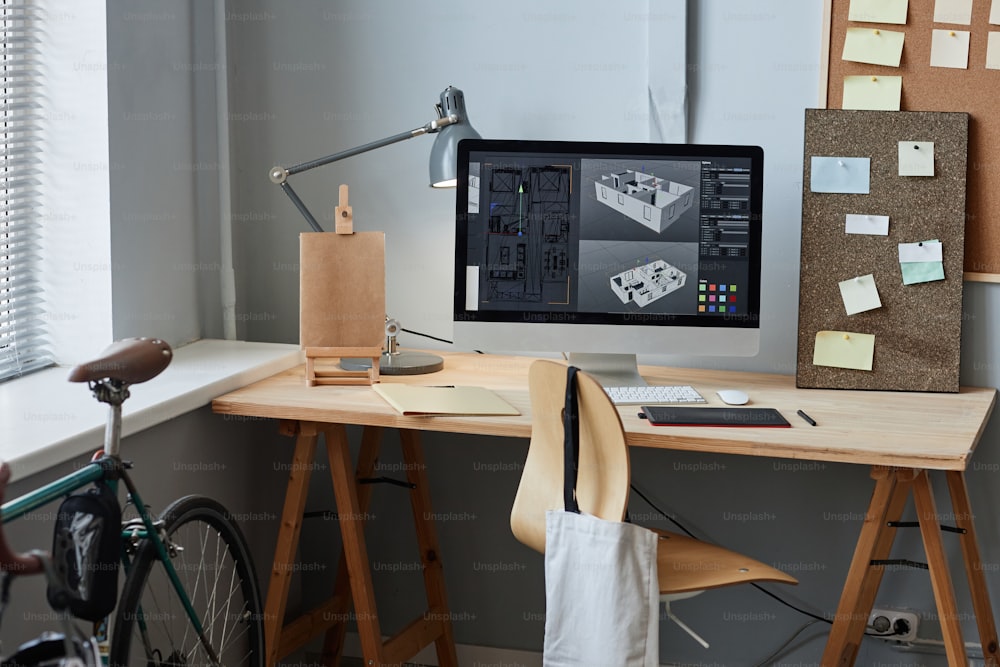 Imagen de fondo de la computadora con modelo de casa 3D en el lugar de trabajo de la oficina en casa, espacio de copia