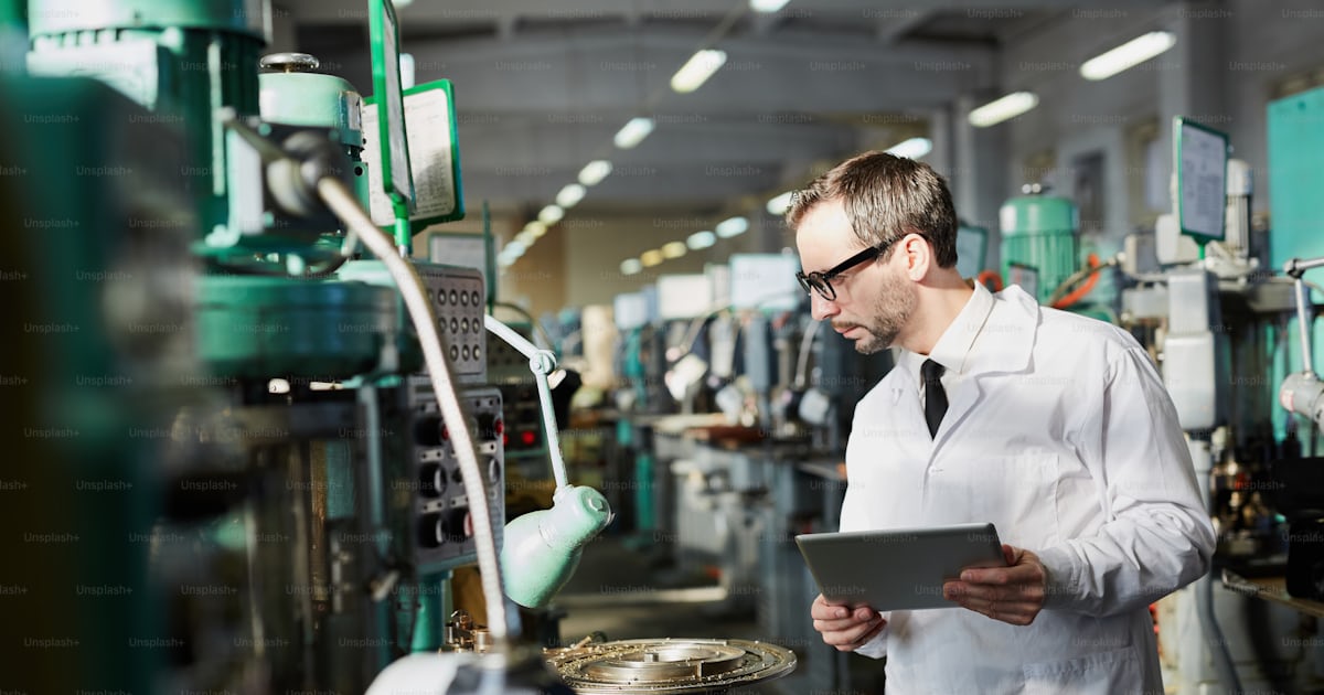 Side view portrait of senior quality inspector wearing lab coat ...