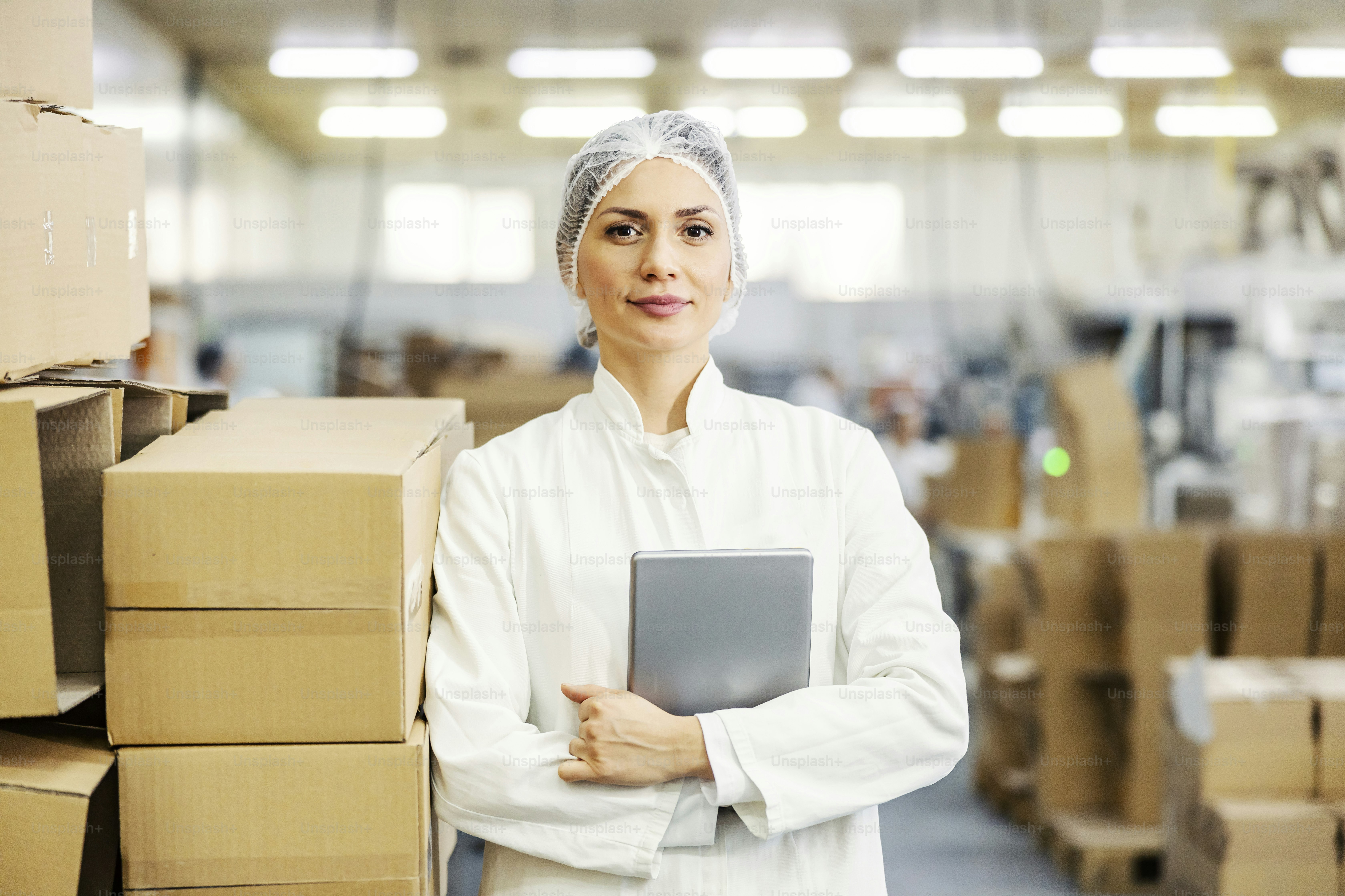 A food factory inspector holding tablet and waiting for instructions ...