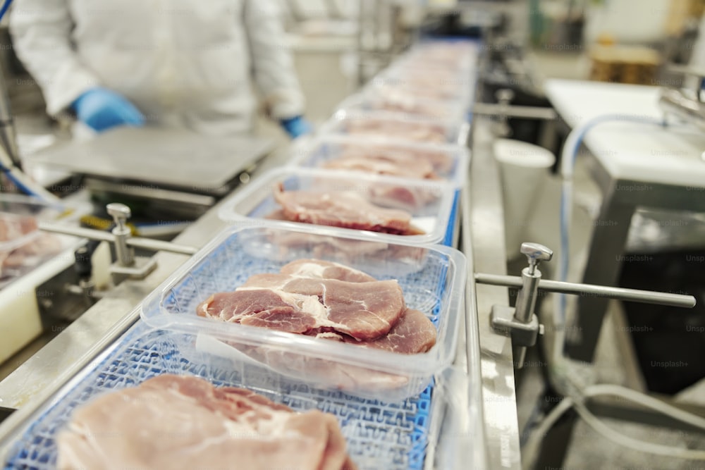 Close up of a meat on a packing machine.