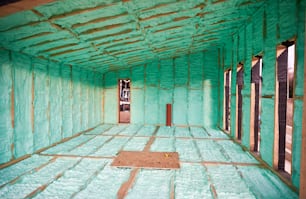 Wooden frame house thermal insulated by polyurethane foam. Construction and insulation concept.