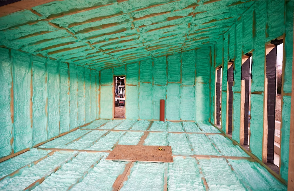 Wooden frame house thermal insulated by polyurethane foam. Construction and insulation concept.