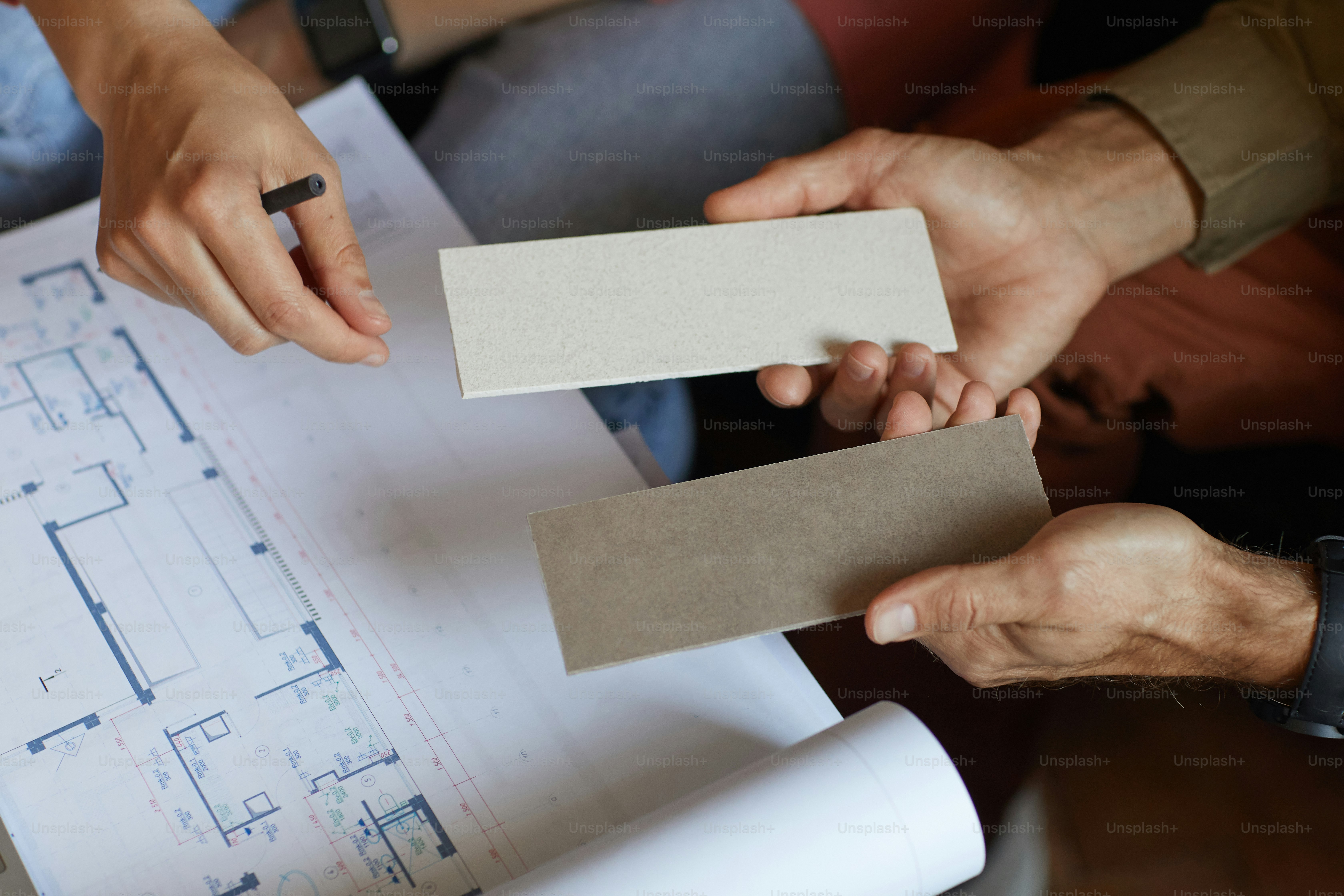 Close-up of people examining the blueprint and working over new project in team