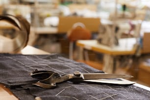 Close-up of details drew by chalk on fabric with scissors on it in workshop