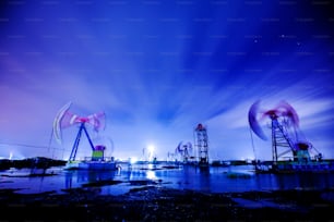 Oil field site, in the evening, oil pumps are running