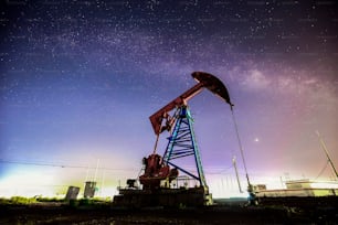 At night, oil pumps under the stars