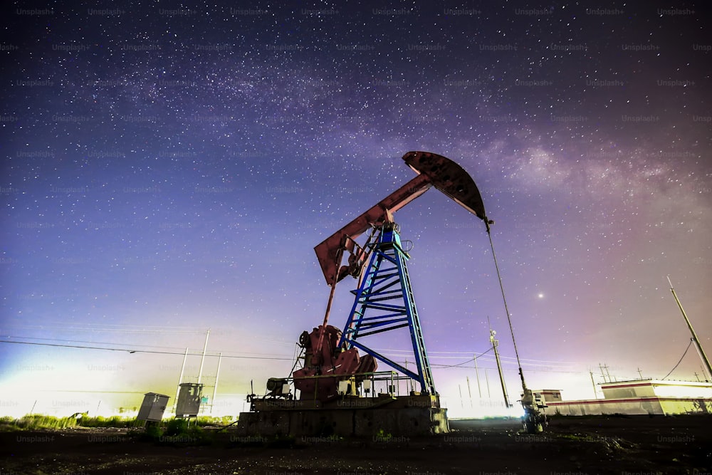 At night, oil pumps under the stars