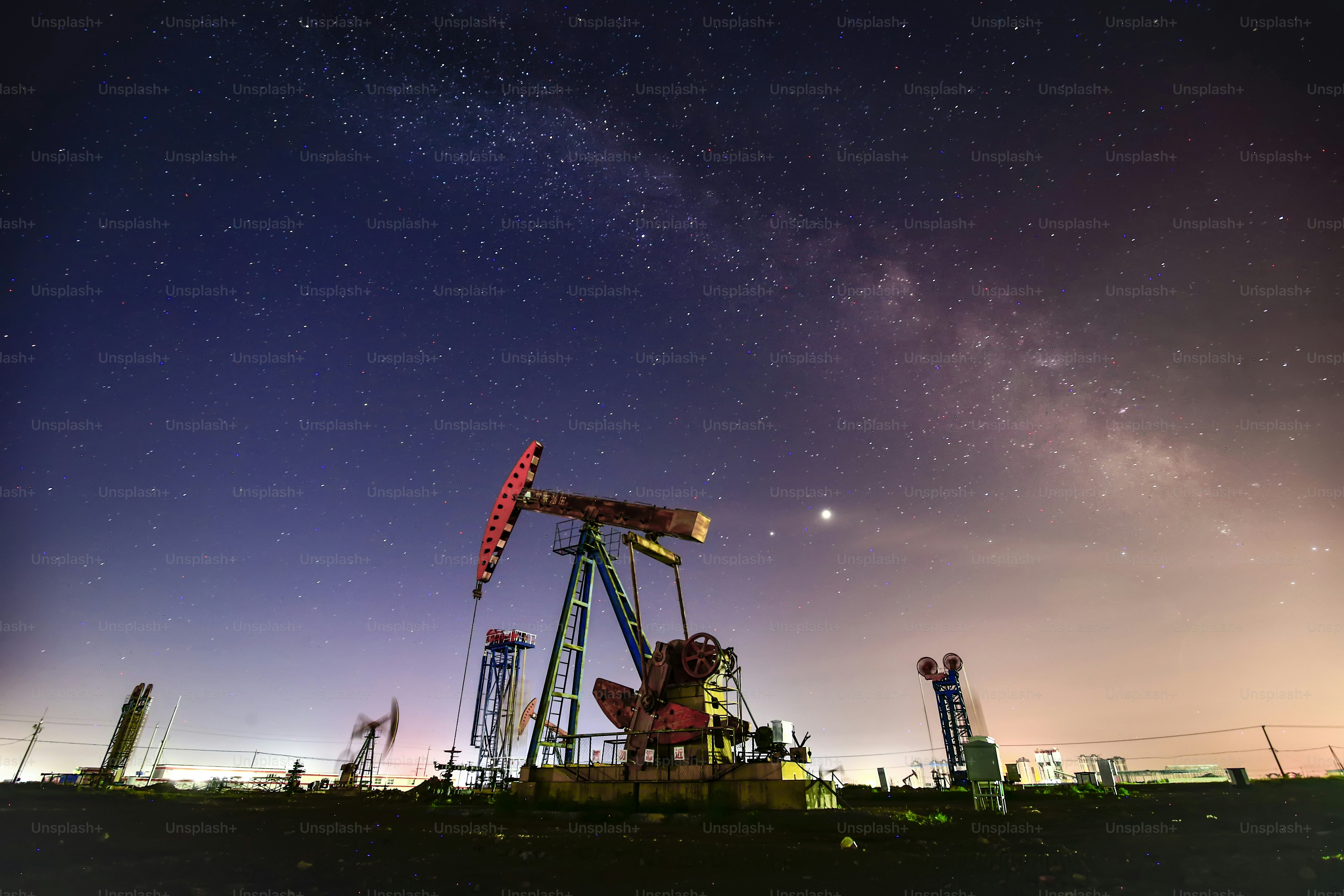 At night, oil pumps under the stars