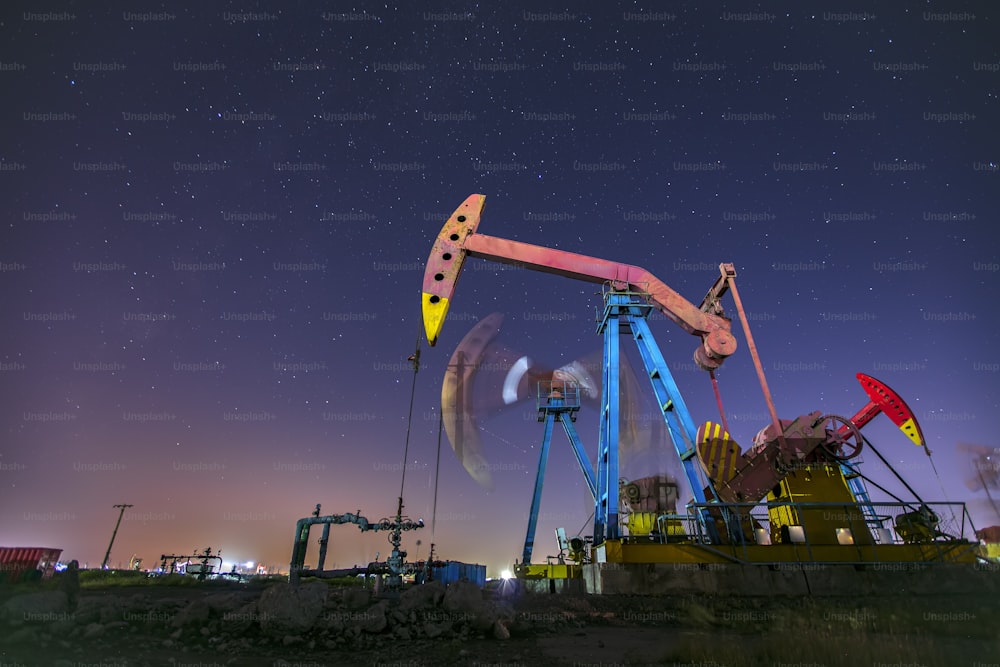 At night, oil pumps under the stars